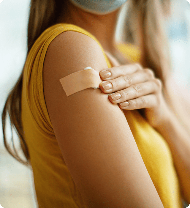 Actor Portrayal; A young, Southeast Asian woman in a yellow blouse, holding a bandage on her upper arm.